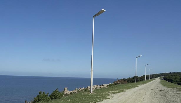 Microfiber cloth cleaning dust/bird droppings from a solar street light panel to boost 30-50% light absorption in weak light