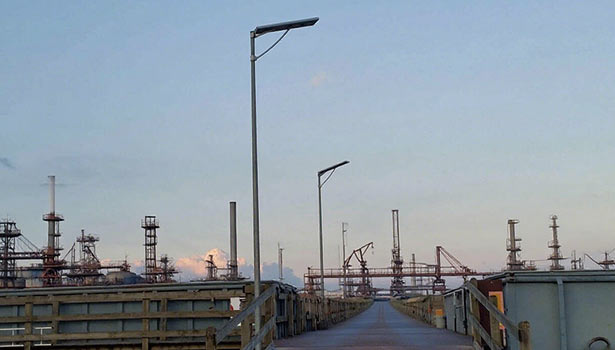 Aluminum foil sheet reflecting urban ambient light (e.g., building lights) onto a shaded solar street light panel for better charging