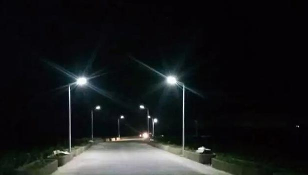 Solar street lights lighting up quiet rural path at night - delivering 8-16 hours of runtime after full charge