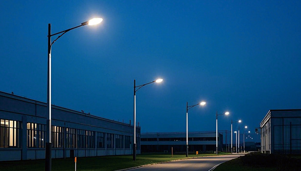 Fully installed solar street light illuminating a road at night