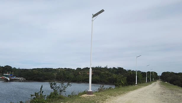 Tall solar street lights used in a wide rural road with farmland scenery