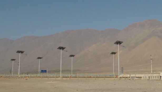 Multiple solar street lights with a mountainous background