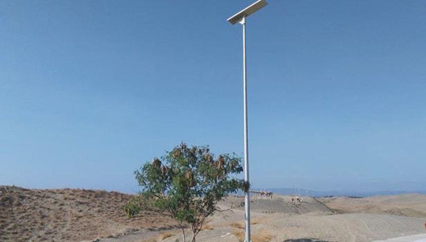 A single solar street light in the desert during the day