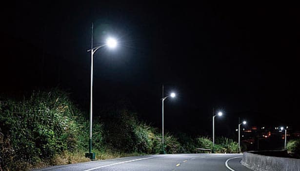 Solar street lights lighting a rural road at night.