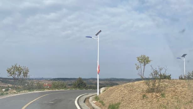 Solar street light along a curved road, highlighting its application in road-side lighting