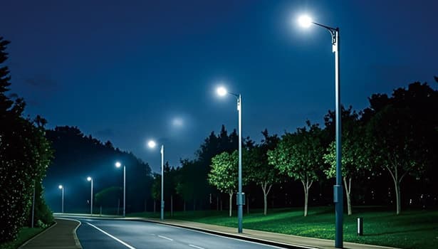 Brightly lit solar street lights along a road at night, highlighting nighttime performance and efficiency